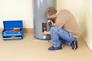 Jake is checking the wiring on a water heater repair in Oceanside job